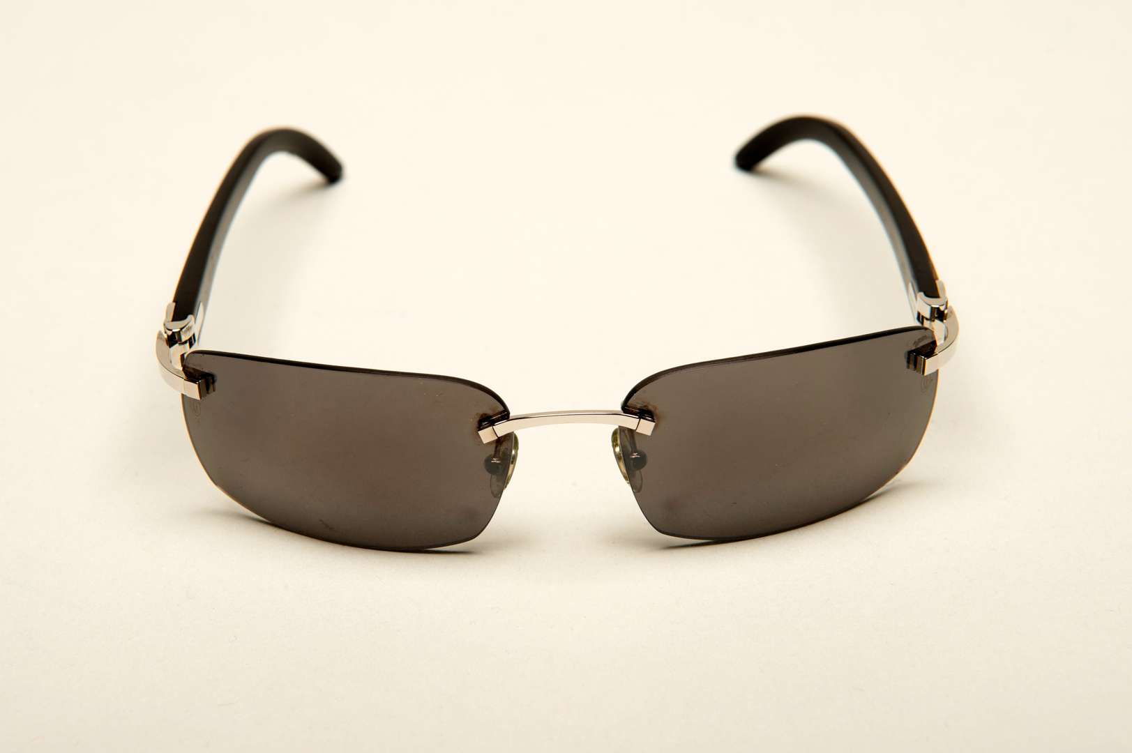 <p>CARTIER, a &nbsp;pair of French rimless, horn armed sunglasses</p>