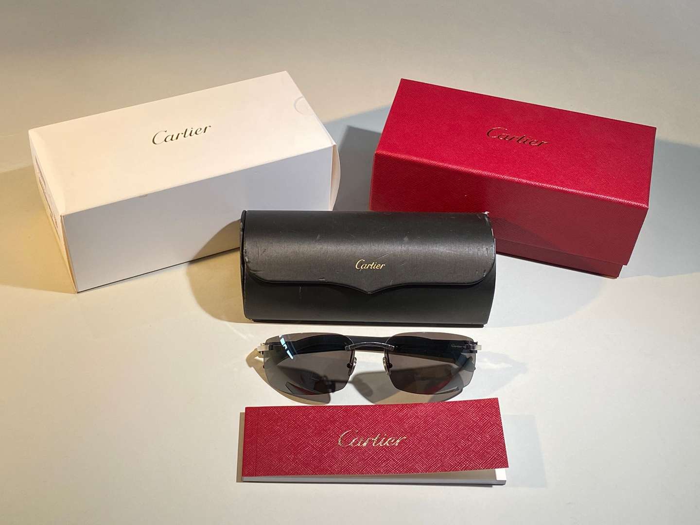 <p>CARTIER, a &nbsp;pair of French rimless, horn armed sunglasses</p>