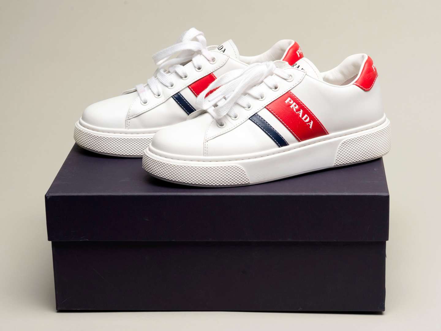 <p>PRADA, a pair of Bianco+ Rosso, Vitello Soft sneakers</p>