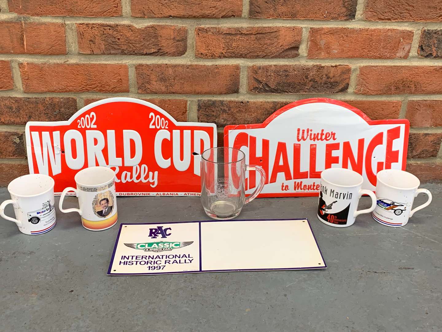 <p>Three Rally Plaques and Five Motoring Mugs</p>