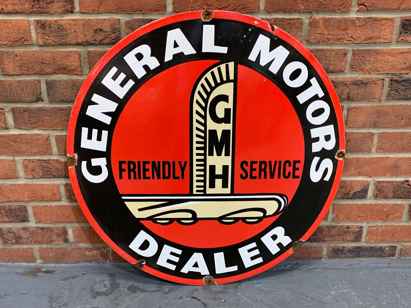 <p>Enamel Circular “General Motors Dealer" Sign</p>