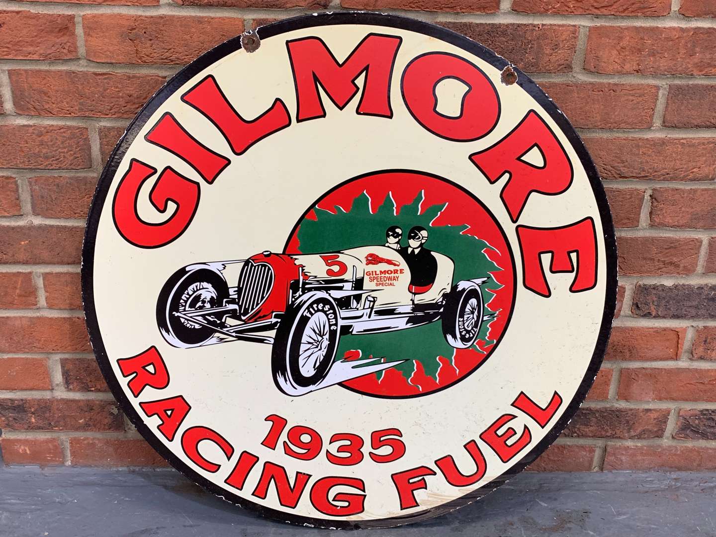 <p>Enamel Circular Gilmore Racing Fuel Sign</p>