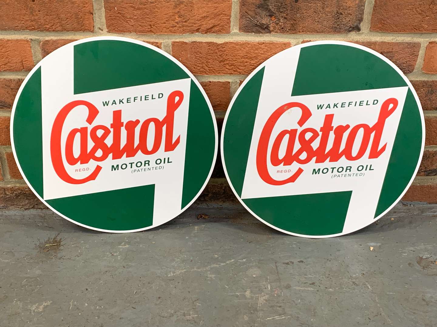 <p>Two Circular Castrol Motor Oils Signs on Fibreboard</p>