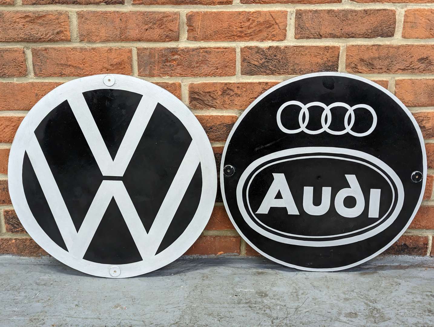 <p>Two Painted VW/Audi Circular Wooden Signs</p>