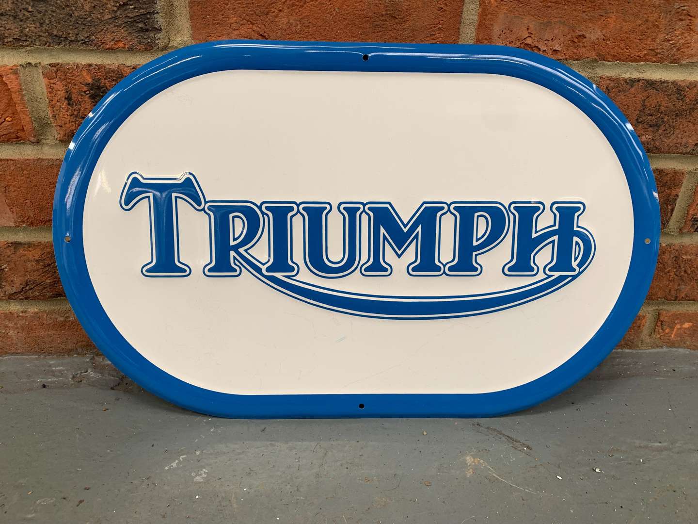 <p>Pressed Metal Triumph Oval Sign</p>