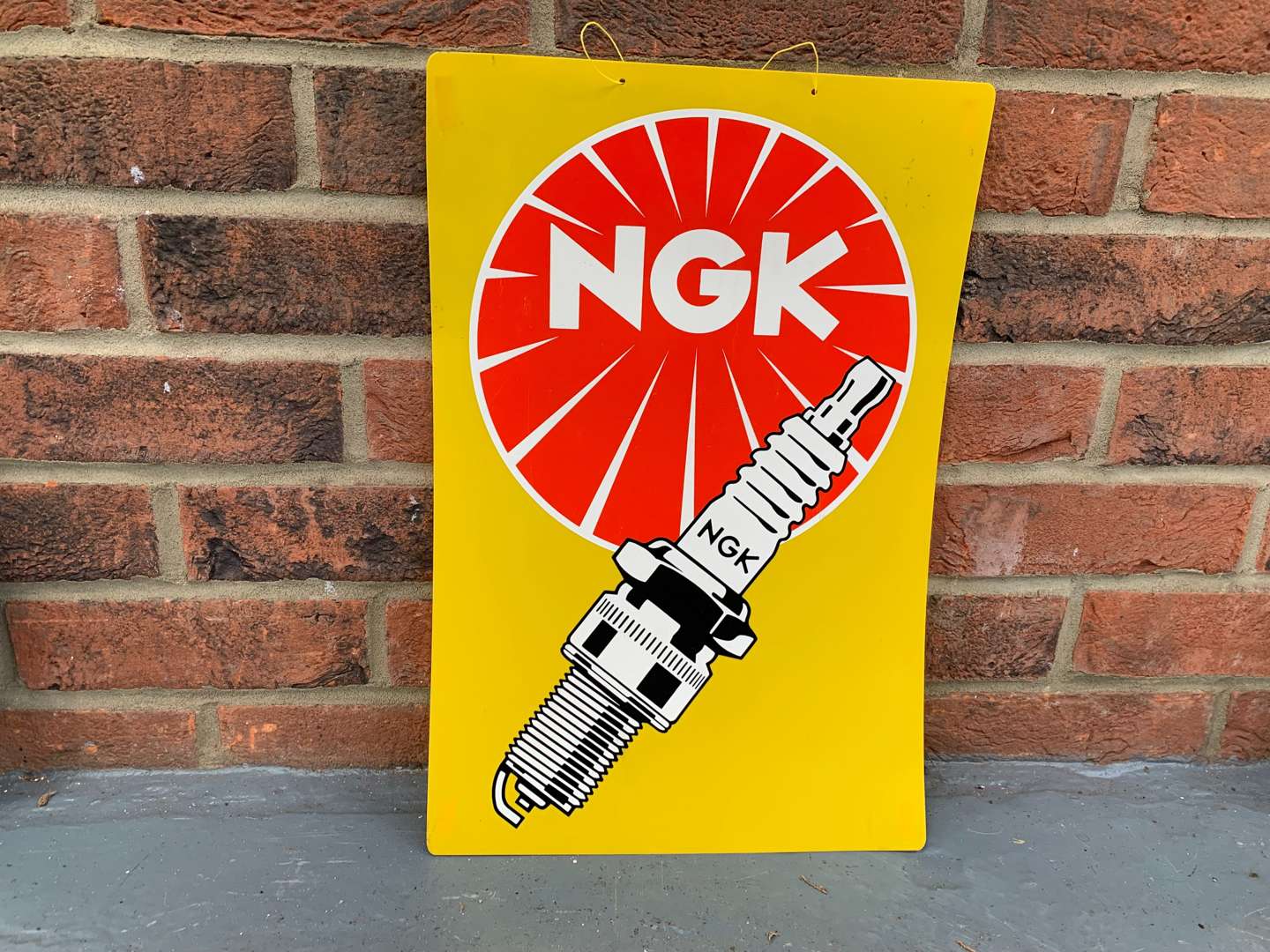 <p>Plastic NGK Spark Plug Sign</p>