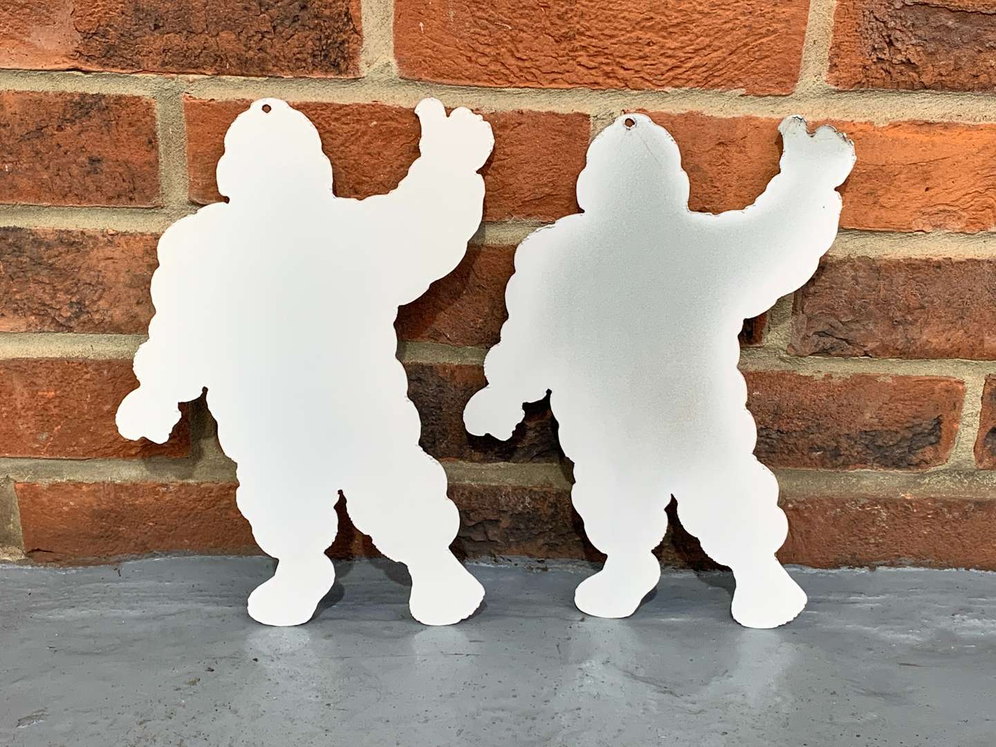 <p>Pair of Metal Small Michelin Men Signs</p>