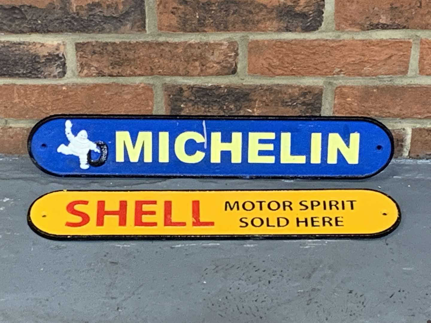 <p>Two Cast Iron Michelin and Shell Signs</p>