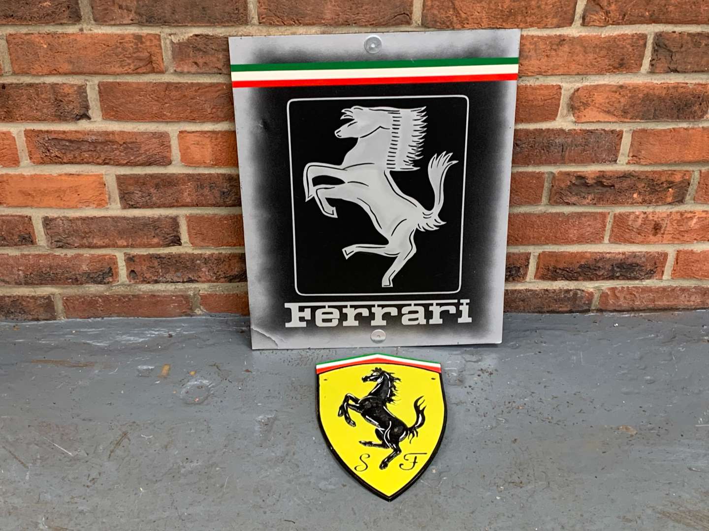 <p>Painted Ferrari Sign and Cast Iron Plaque (2)</p>