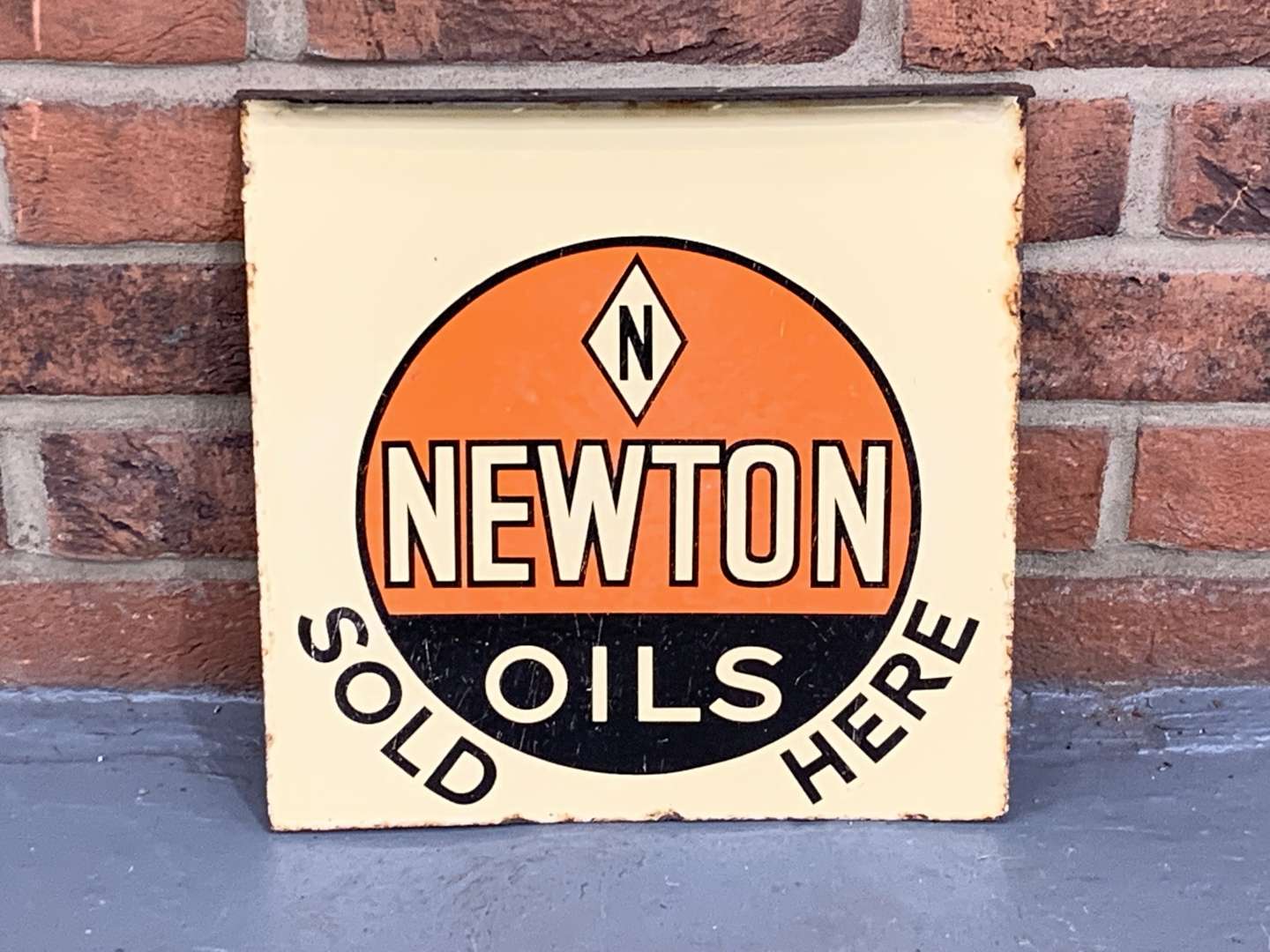 <p>Enamel Newton Oils Sold Here Flange Sign</p>