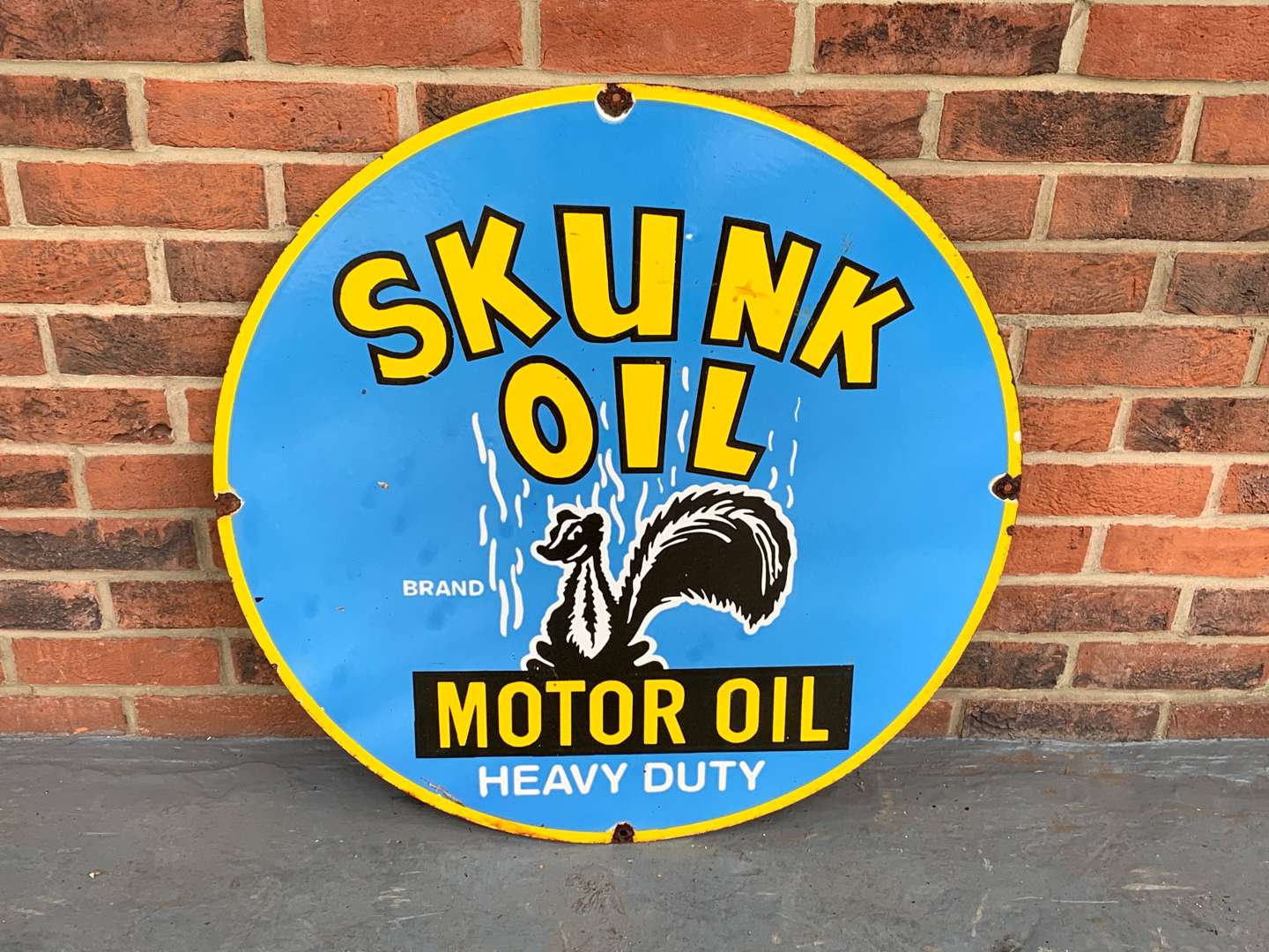 <p>Enamel Skunk Motor Oil Circular Sign</p>