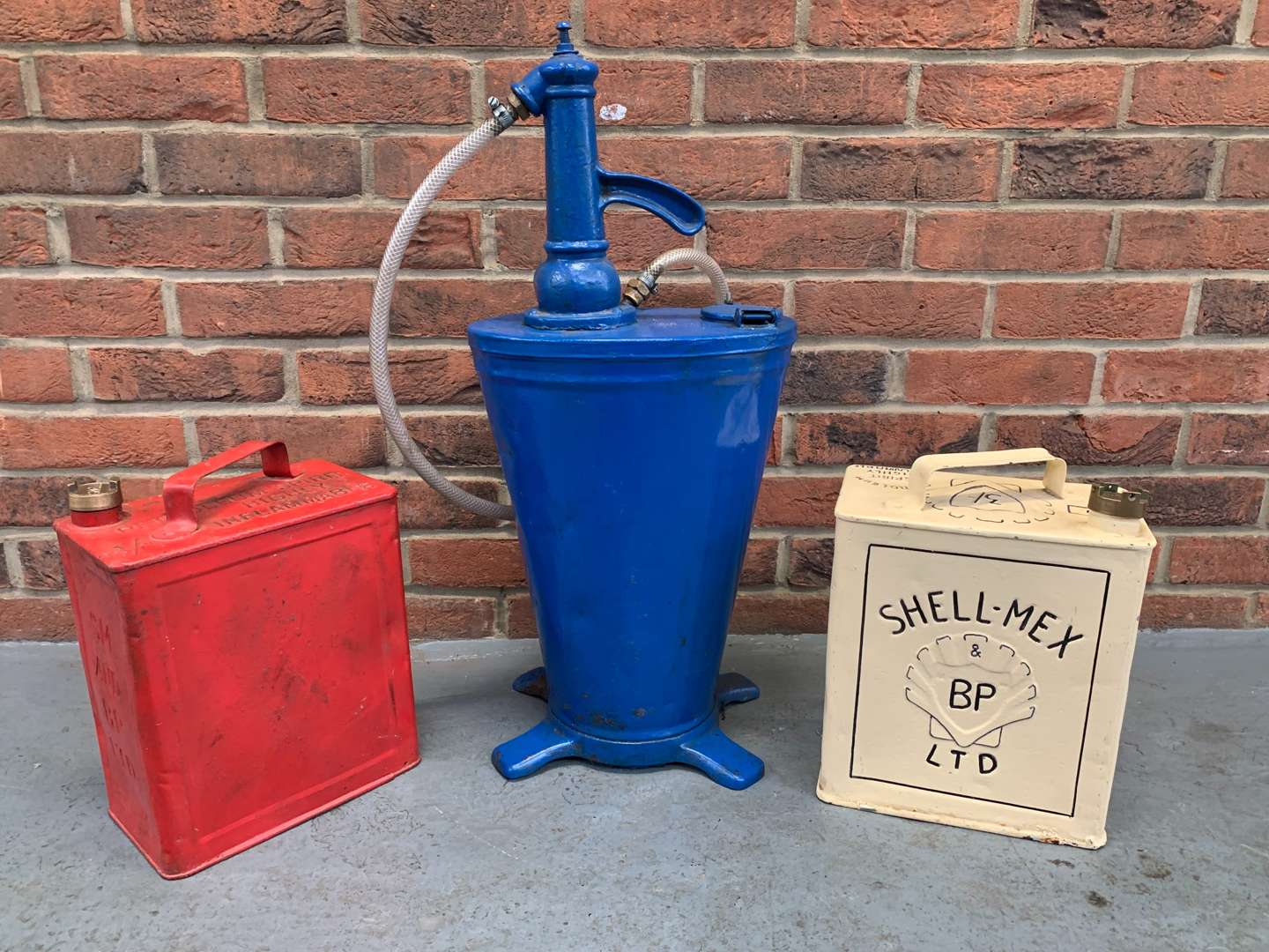 <p>Forecourt Oil Dispenser and Two Five Gallon Fuel Cans (3)</p>