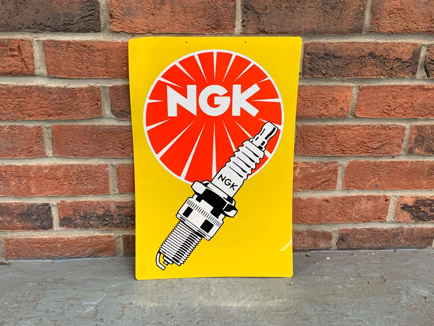 <p>Plastic NGK Spark Plug Sign</p>