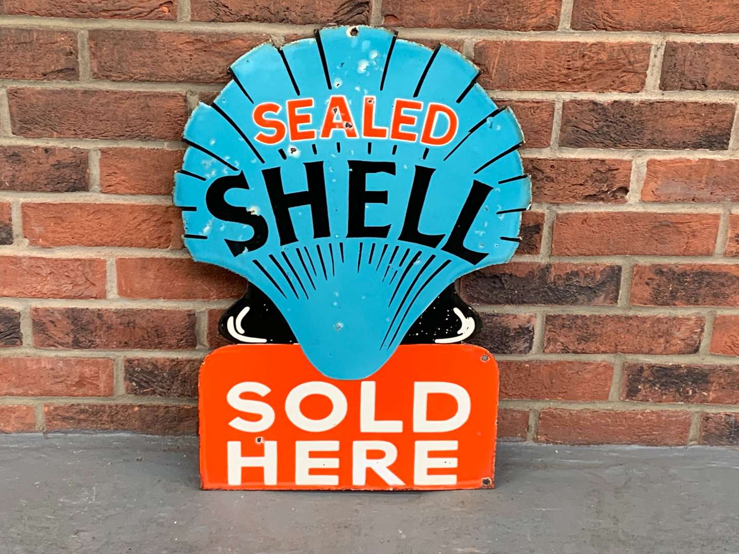 <p>Enamel Sealed Shell Sold Here Double Sided Sign</p>
