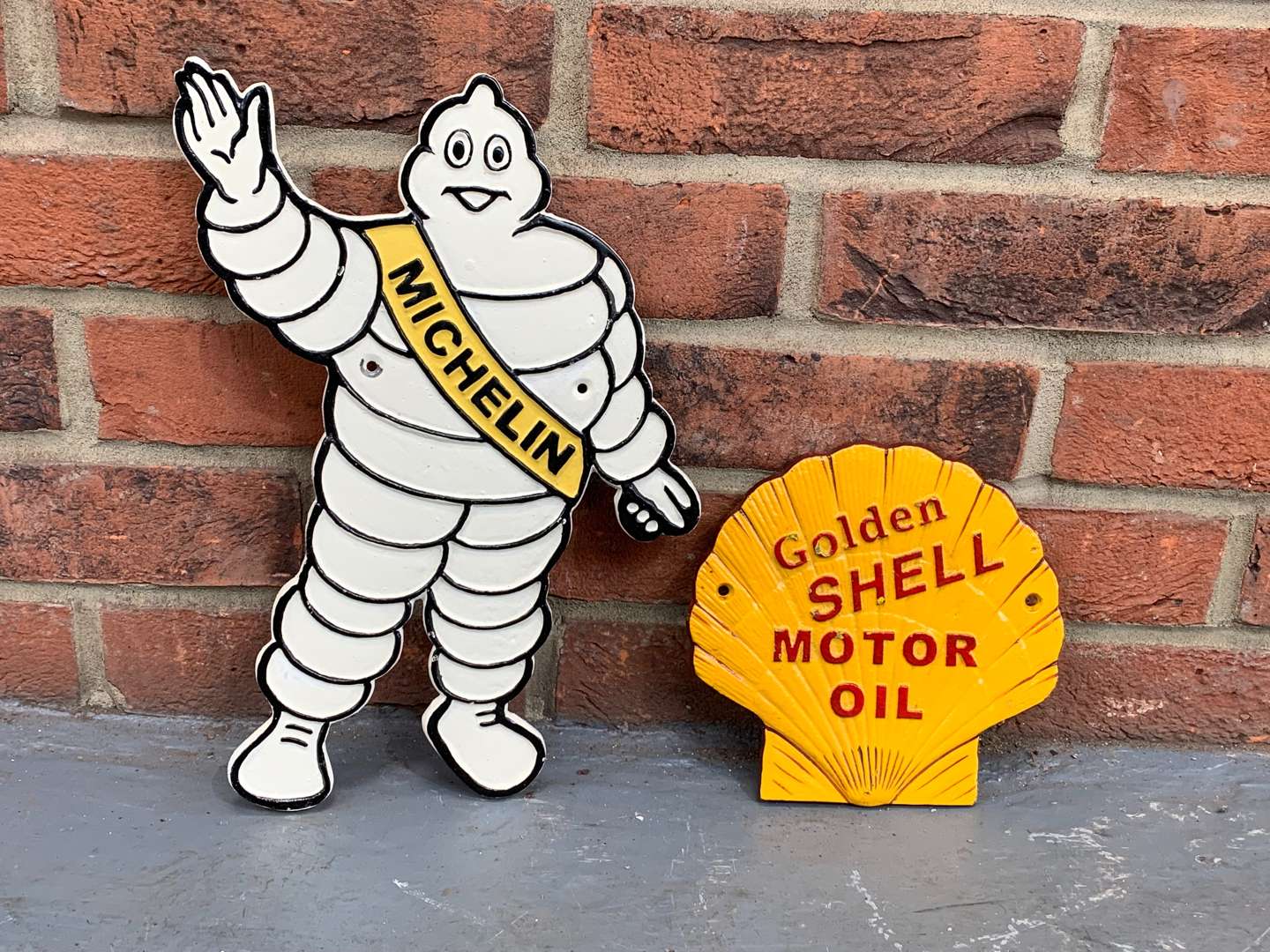 <p>Cast Iron Michelin Man and Golden Shell Oils (2)</p>