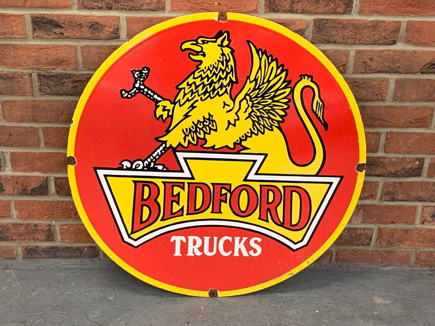 <p>Enamel Bedford Trucks Circular Sign</p>