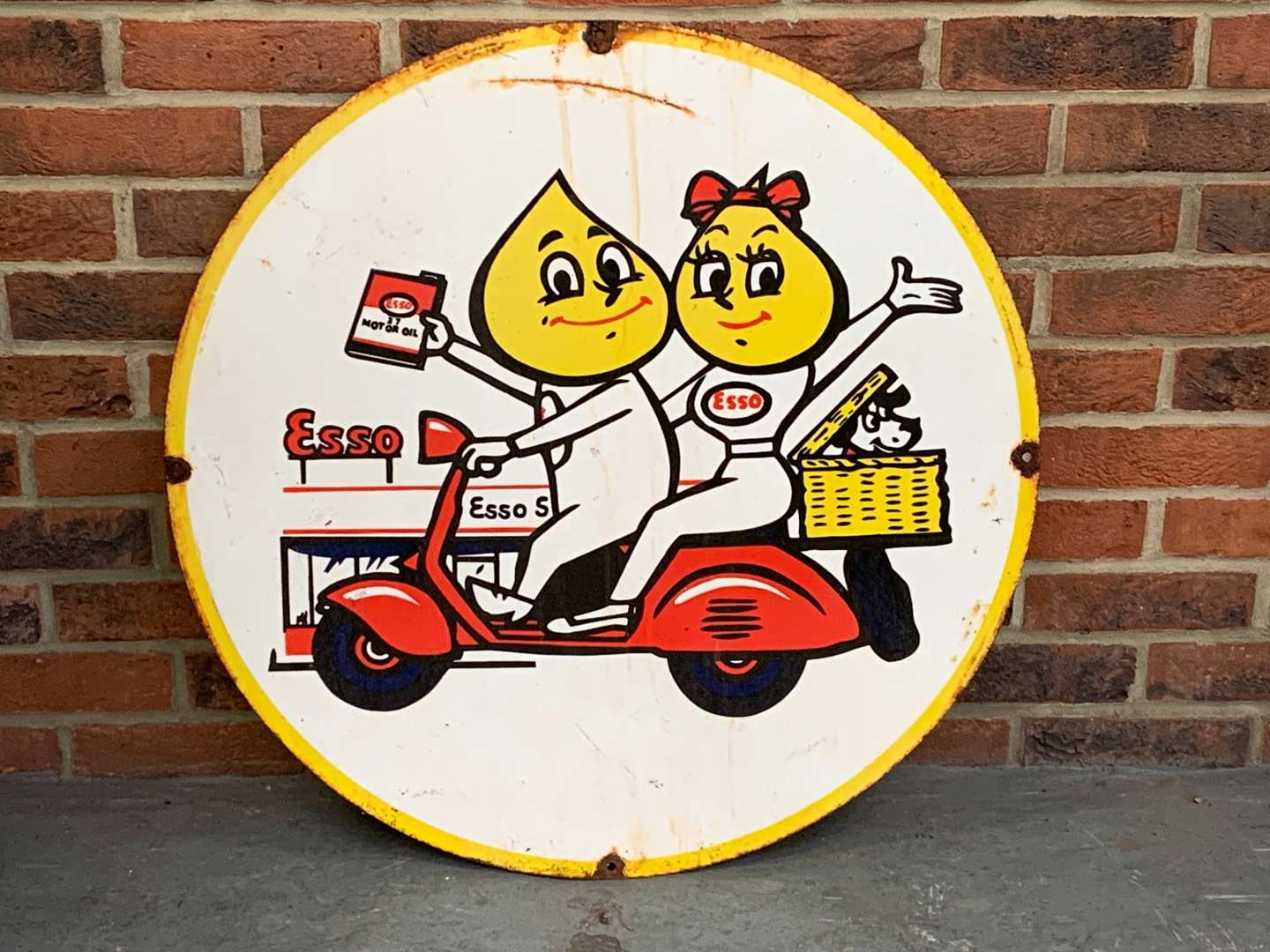 <p>Esso Mr and Mrs Drip on a Scooter Enamel Circular Sign</p>