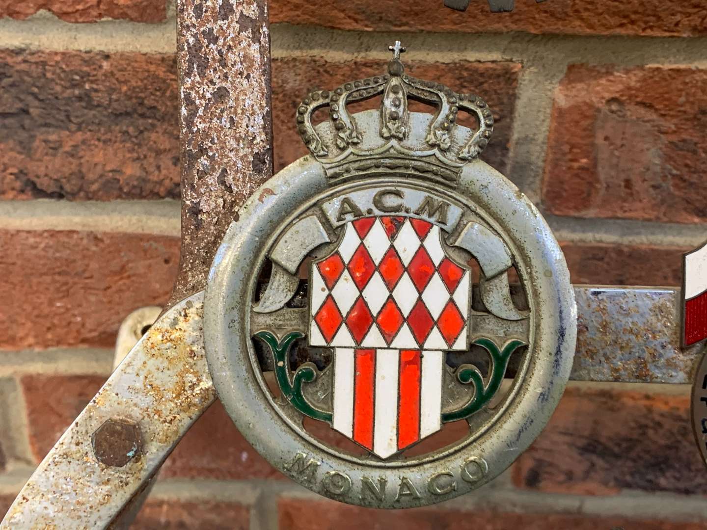 <p>A Significant Collection of Pre-War Badges on a Bar</p>