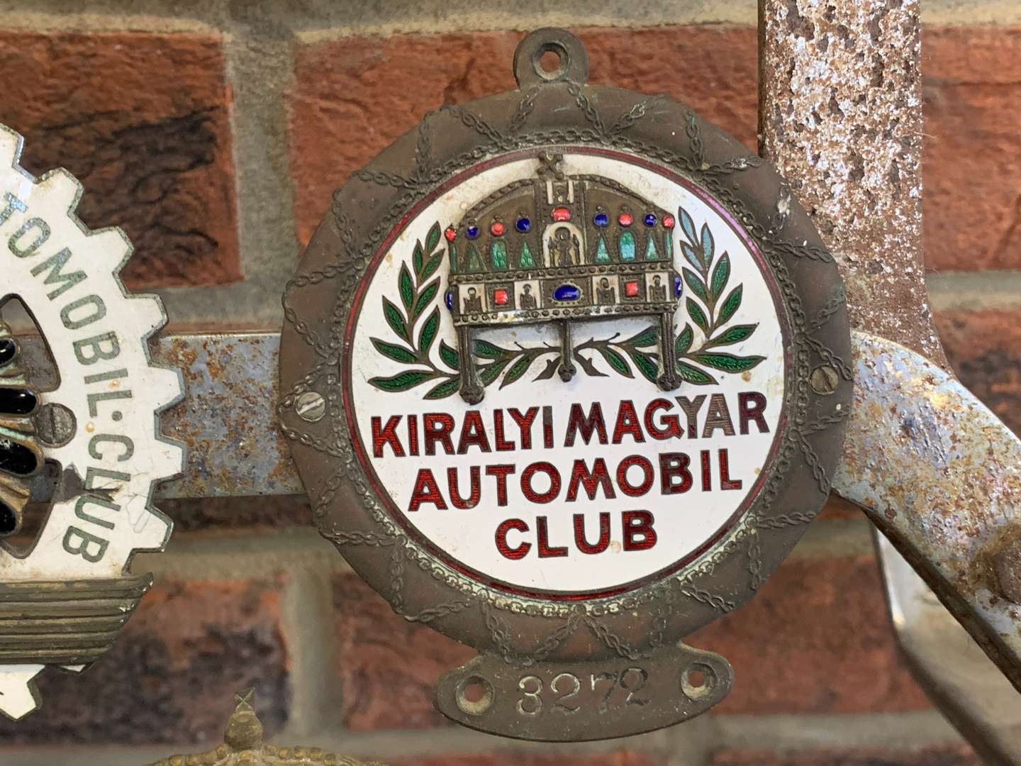 <p>A Significant Collection of Pre-War Badges on a Bar</p>