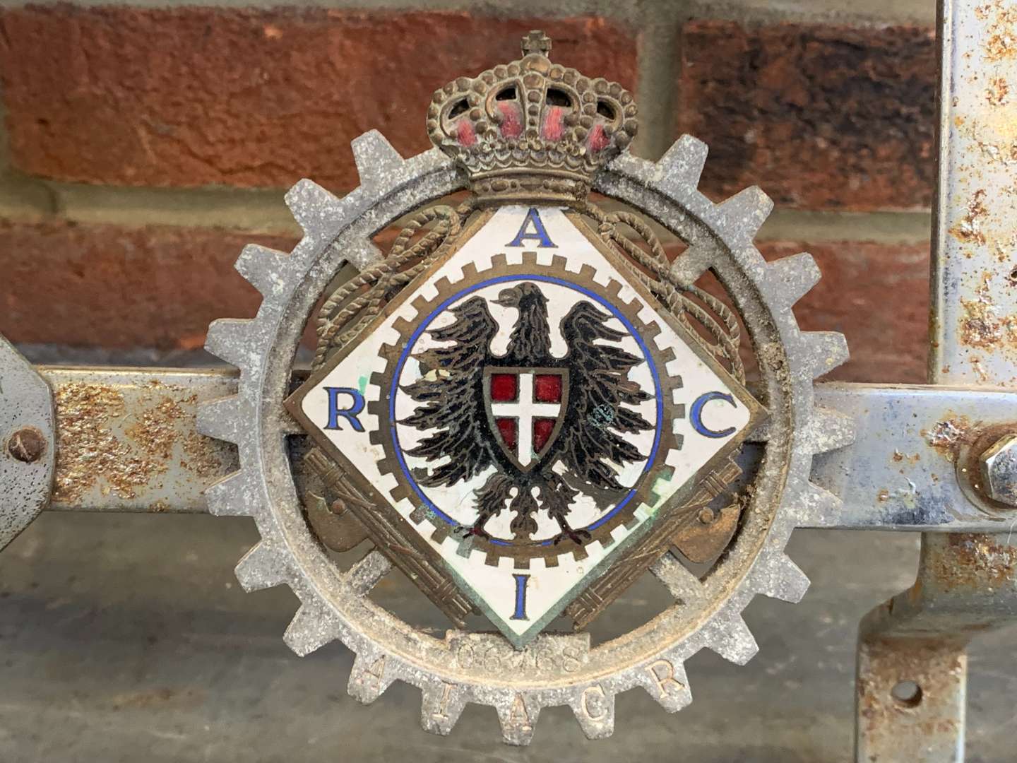 <p>A Significant Collection of Pre-War Badges on a Bar</p>