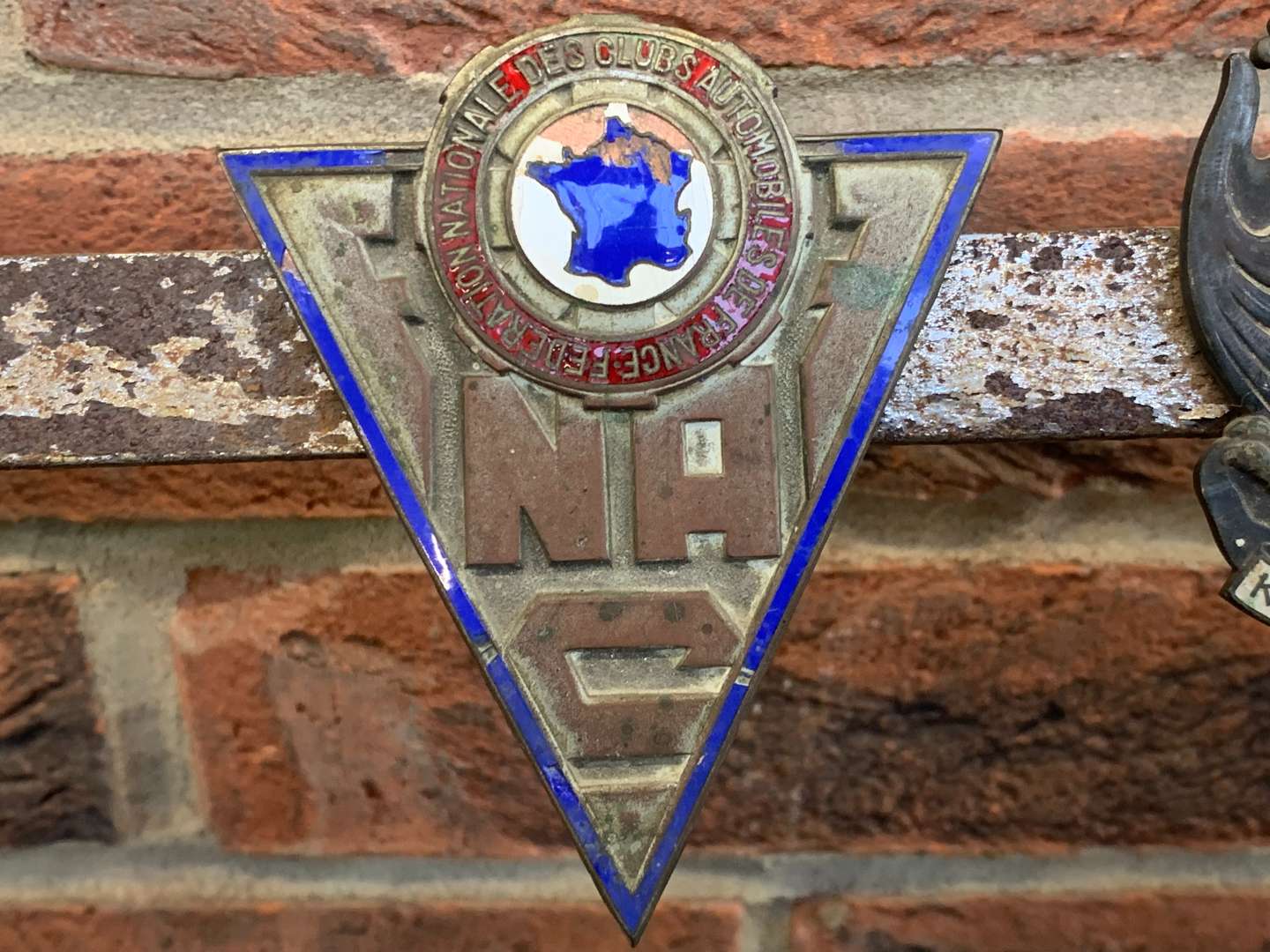 <p>A Significant Collection of Pre-War Badges on a Bar</p>