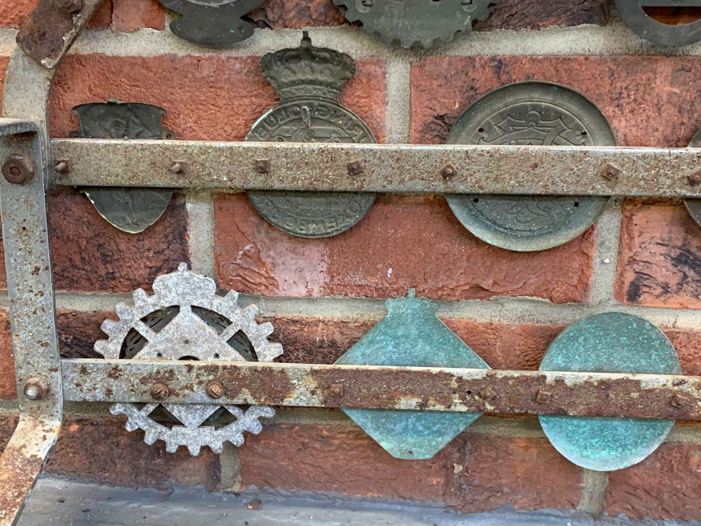 <p>A Significant Collection of Pre-War Badges on a Bar</p>