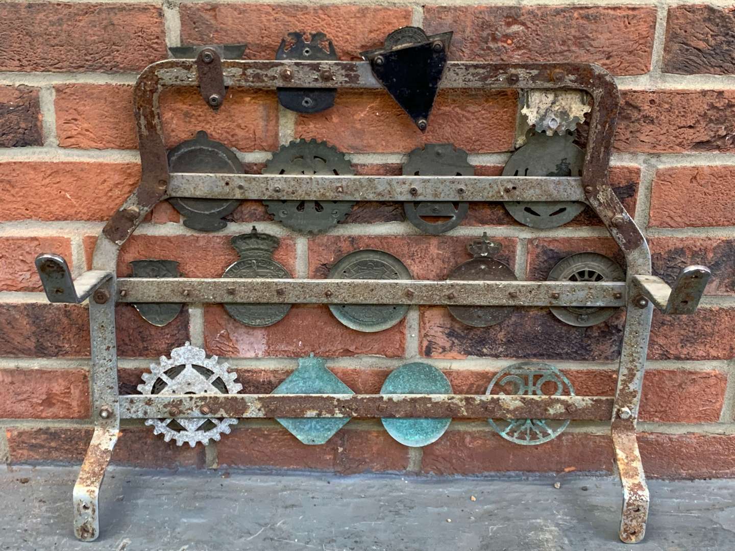 <p>A Significant Collection of Pre-War Badges on a Bar</p>