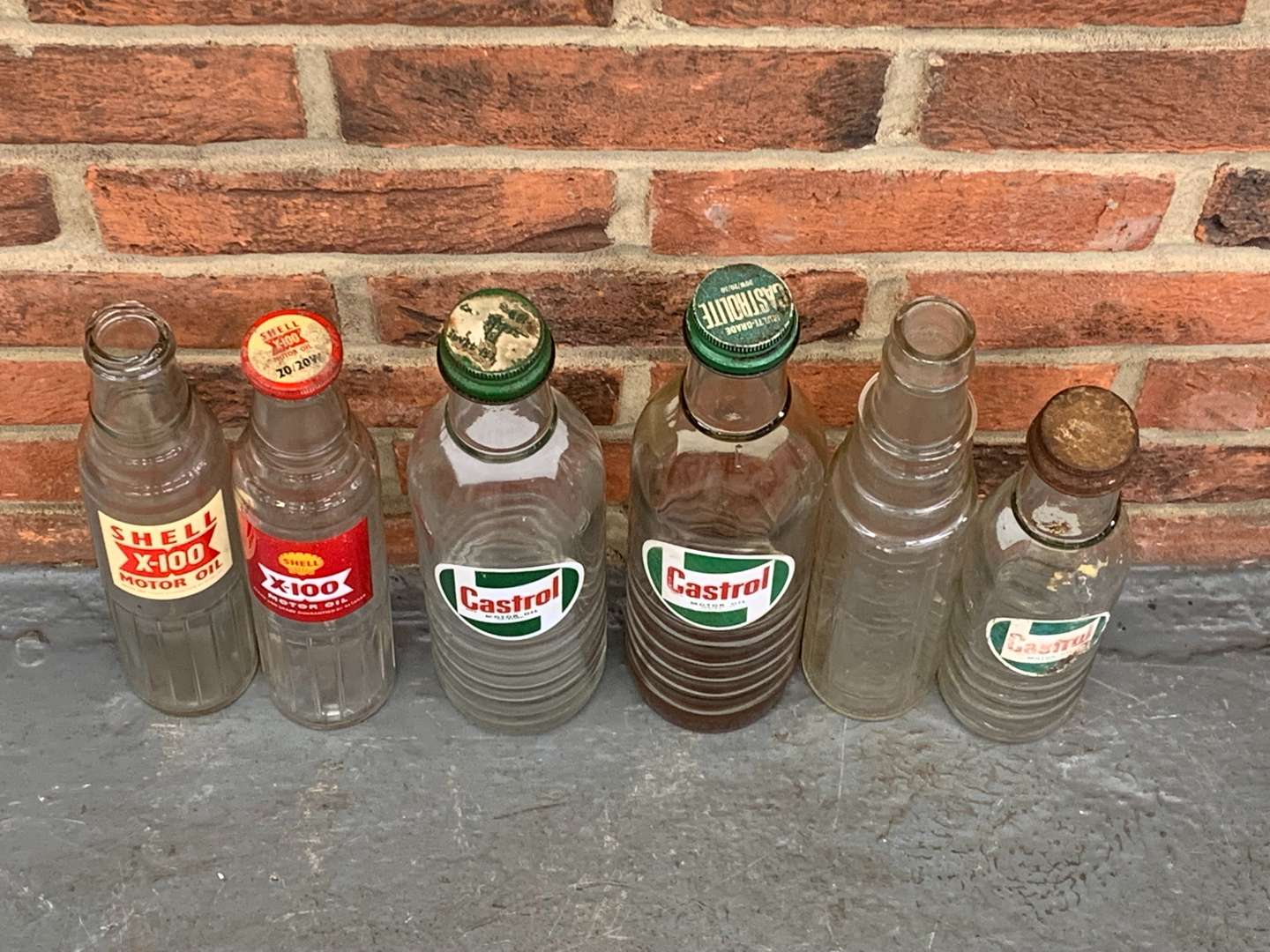 <p>Six Glass Motor Oil Bottles</p>