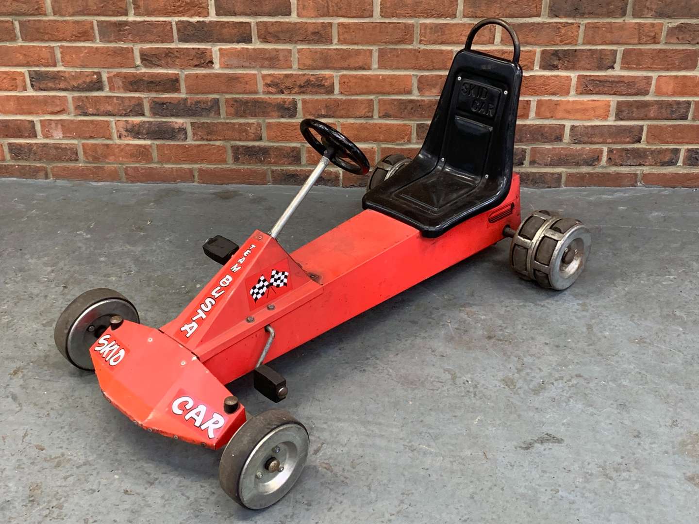 <p>Team Buster Metal Child's Pedal Skid Car</p>