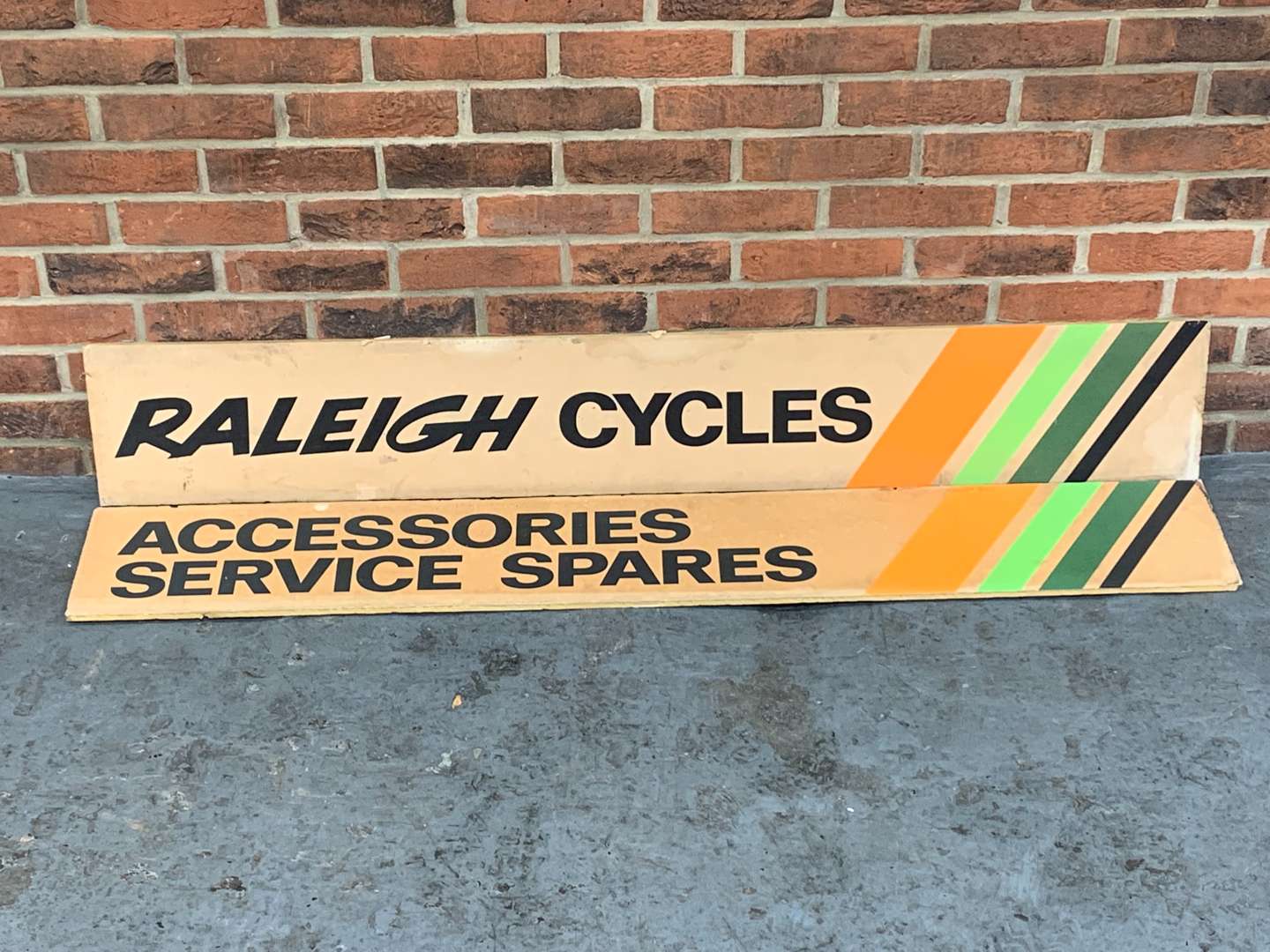 <p>Two Raleigh Cycle Advertising Signs on Card</p>