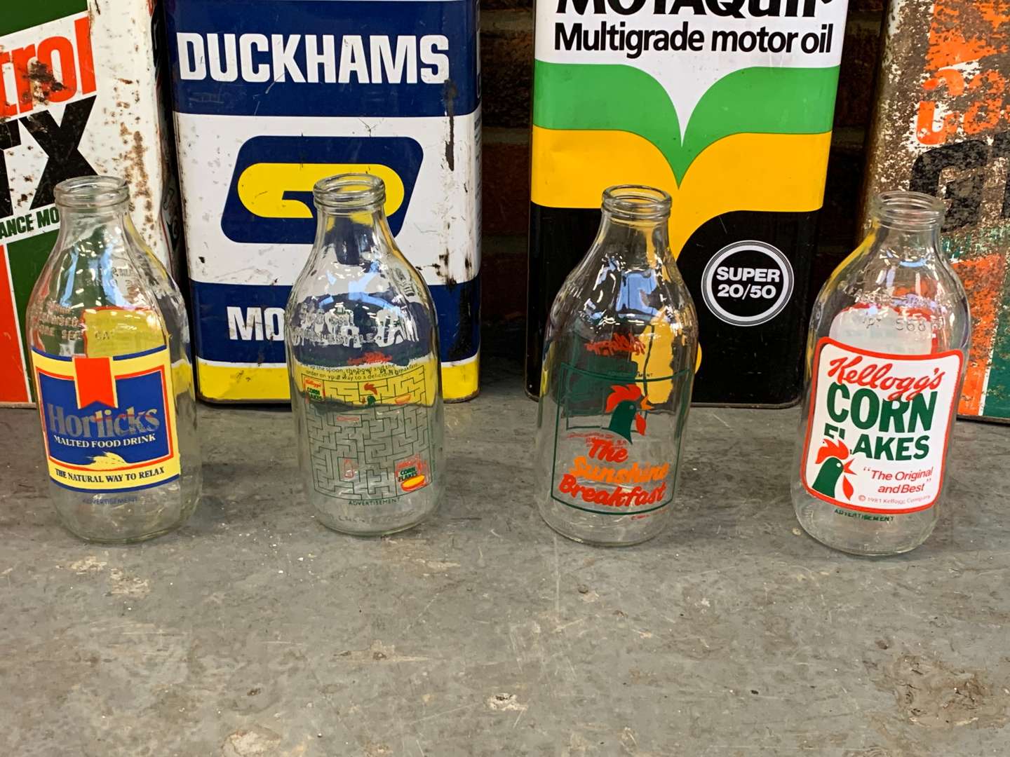 <p>Eight Oil Cans and Four Vintage Milk Bottles (12)</p>