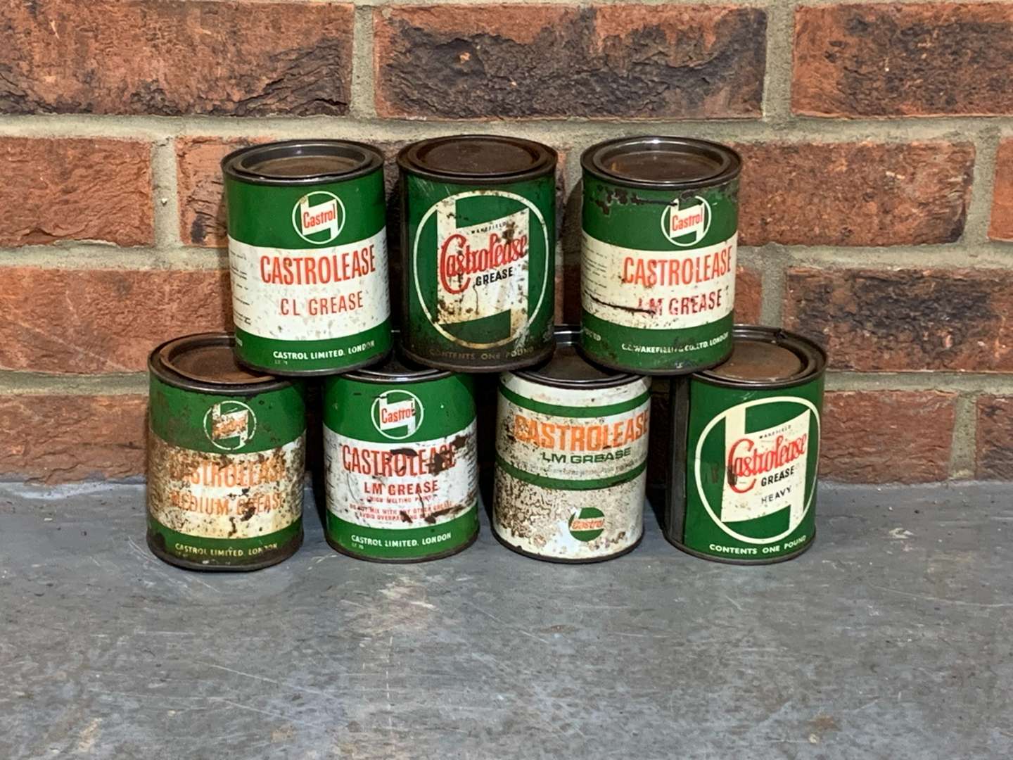 <p>Seven Castrol Grease Cans</p>