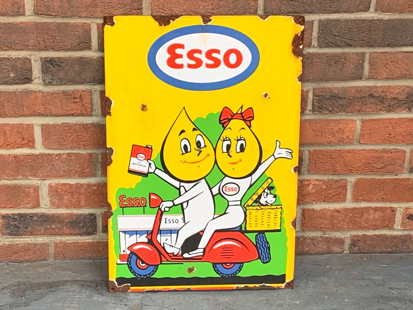 <p>Esso Mr and Mrs Drip On A Scooter Enamel Sign</p>