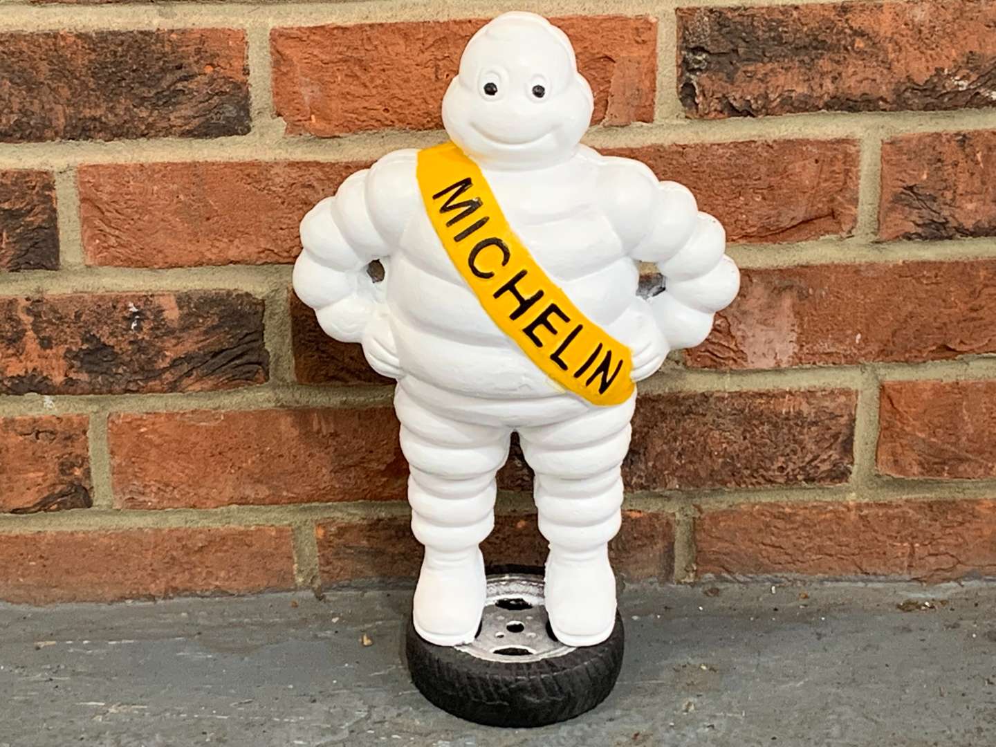 <p>Cast Iron Painted Michelin Man on A Tyre</p>