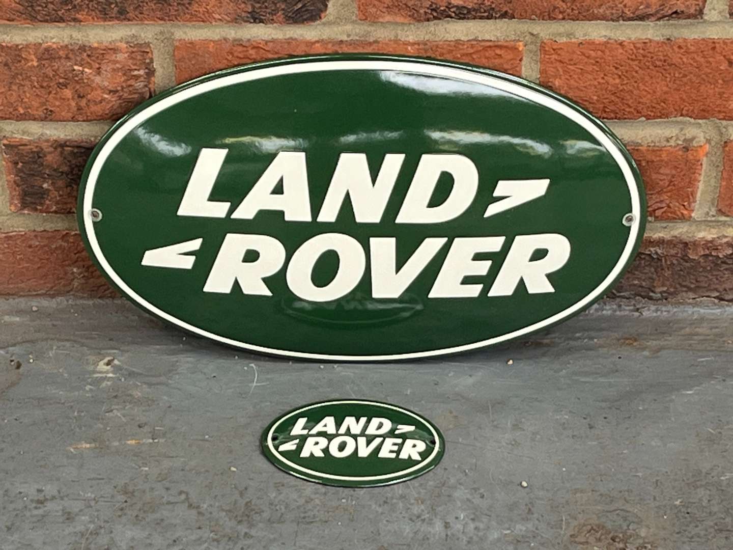 <p>Land Rover Enamel Oval Emblem and Smaller Sign (2)</p>