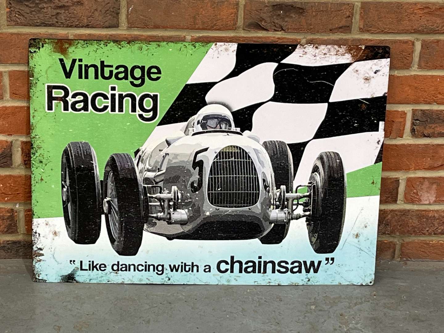 <p>Vintage Racing "Like Dancing With A Chainsaw Tin Sign</p>