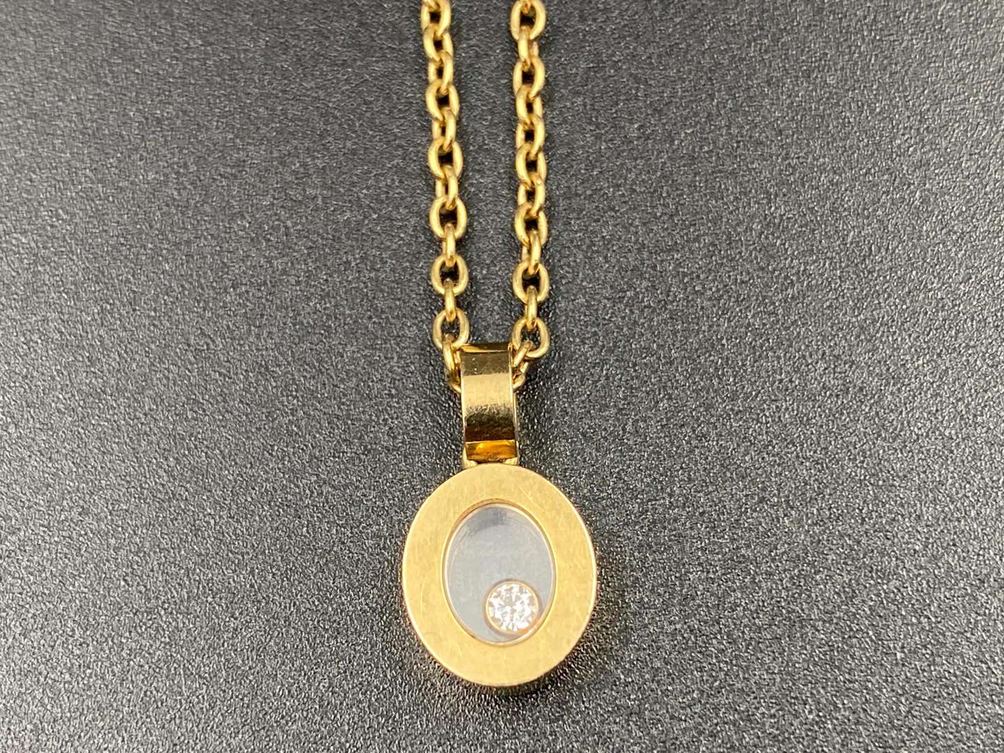 <p>CHOPARD, “Happy Diamond”, 18ct gold, glazed pendant & trace chain</p>