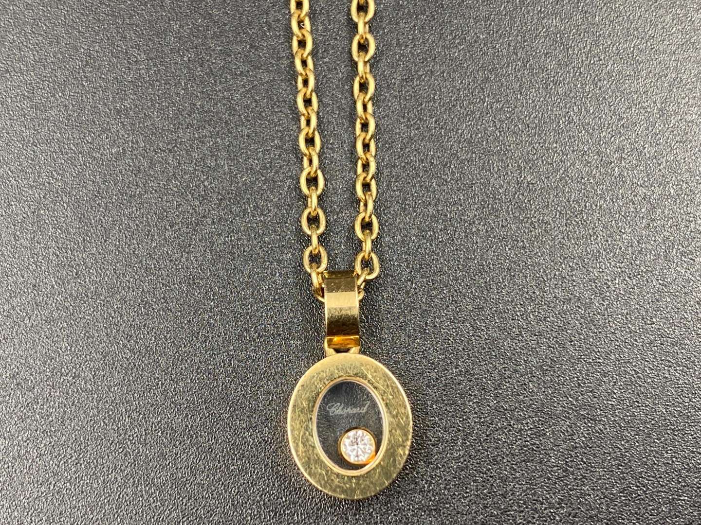 <p>CHOPARD, “Happy Diamond”, 18ct Gold pendant & trace chain</p>