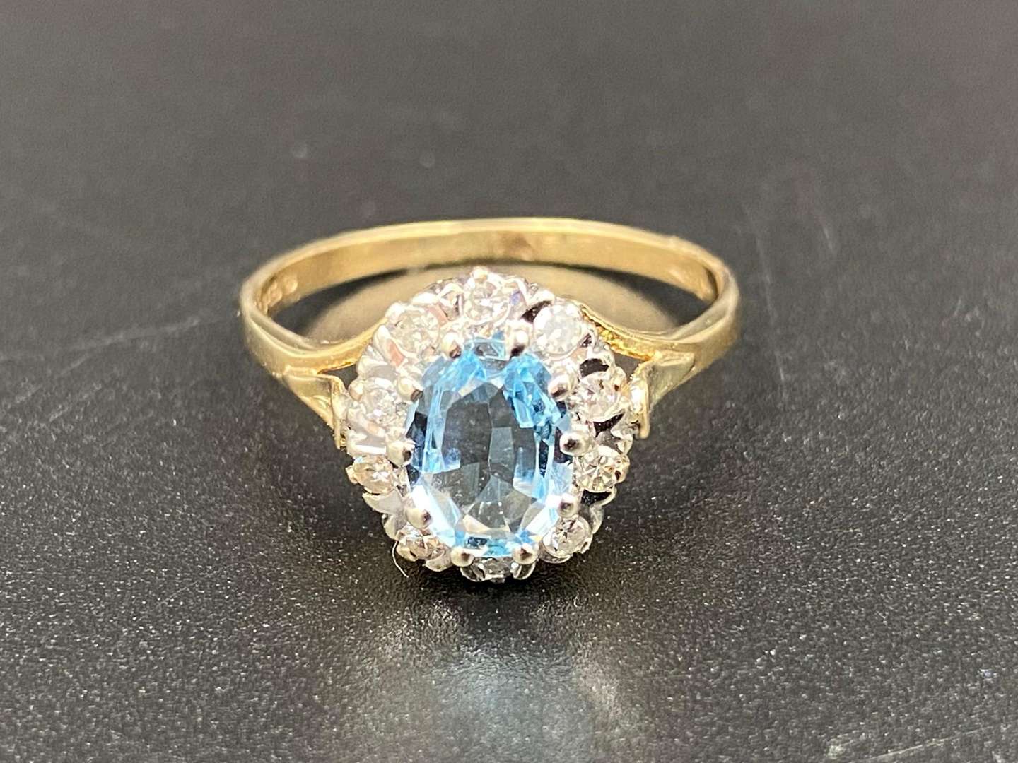 <p>An Aquamarine & Diamond halo ring</p>