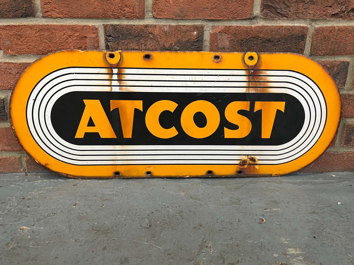 <p>Atcost Enamel Sign</p>