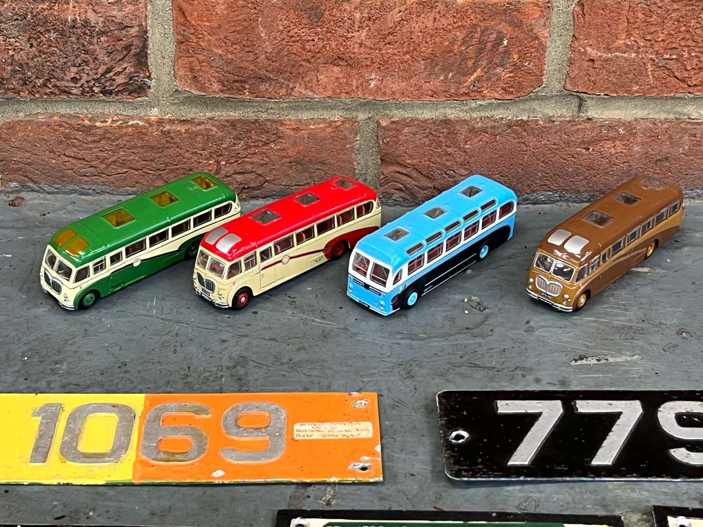 <p>Four Model Buses and Nine Metal Bus Numbers</p>