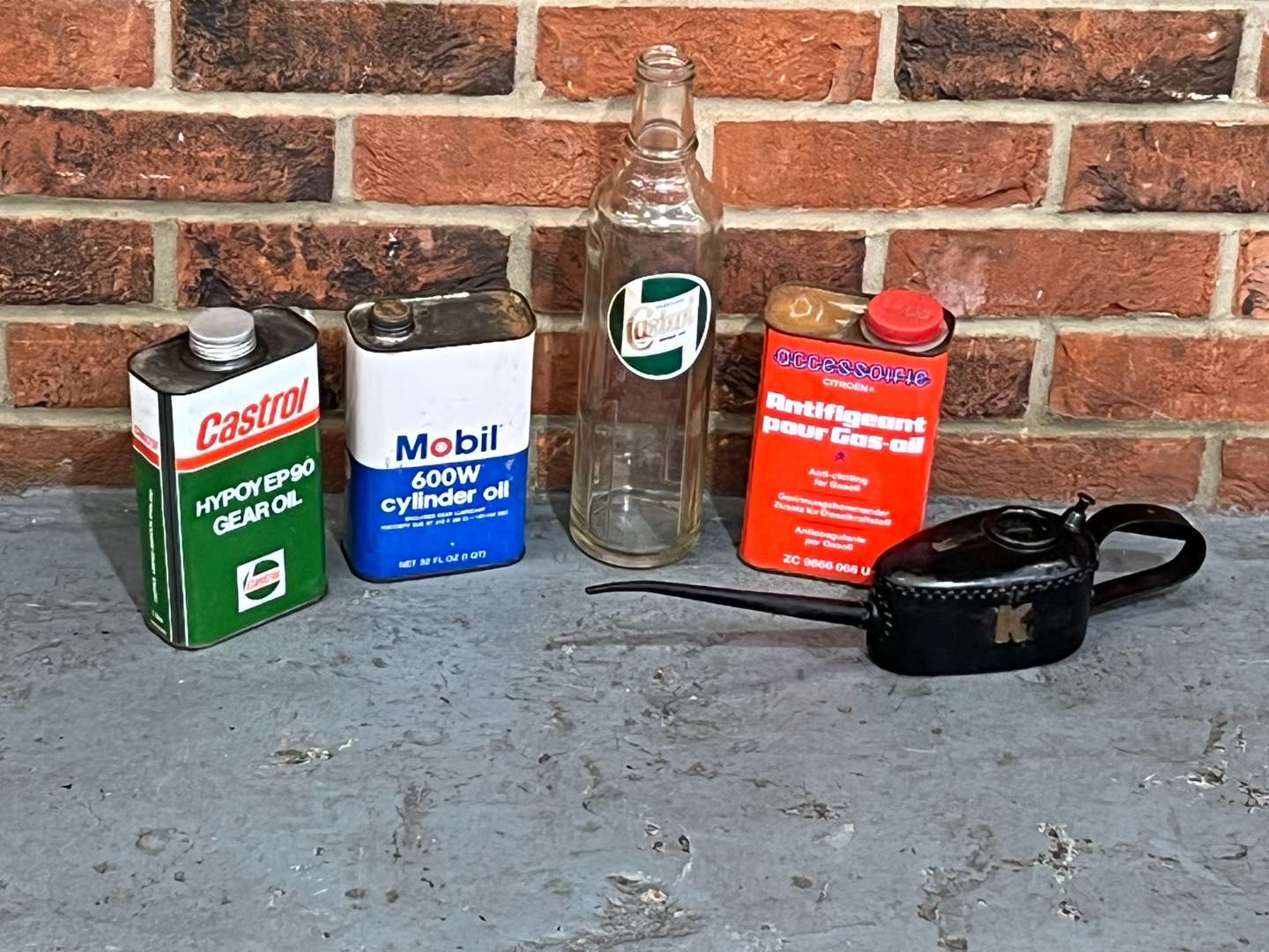 <p>Five Oil Cans and Bottle Mobil, Castrol Etc</p>