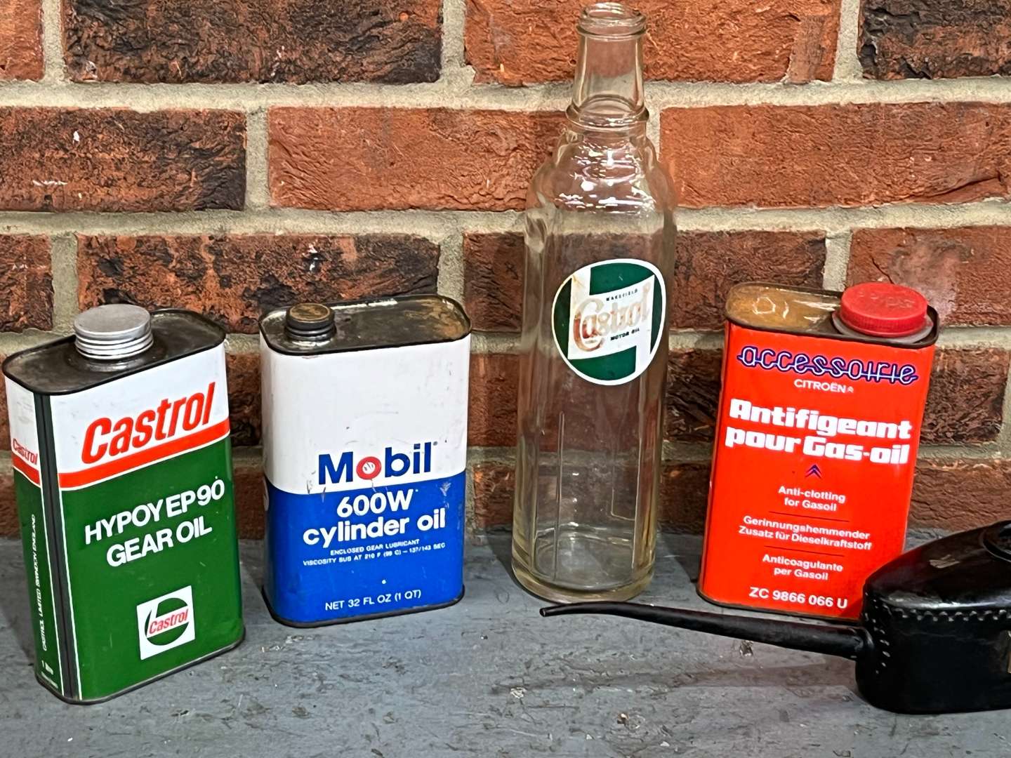 <p>Five Oil Cans and Bottle Mobil, Castrol Etc</p>