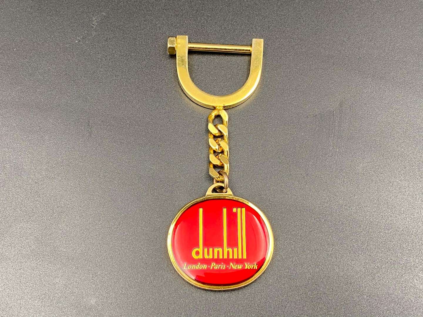 <p>DUNHILL, a gilt plated key ring,</p>