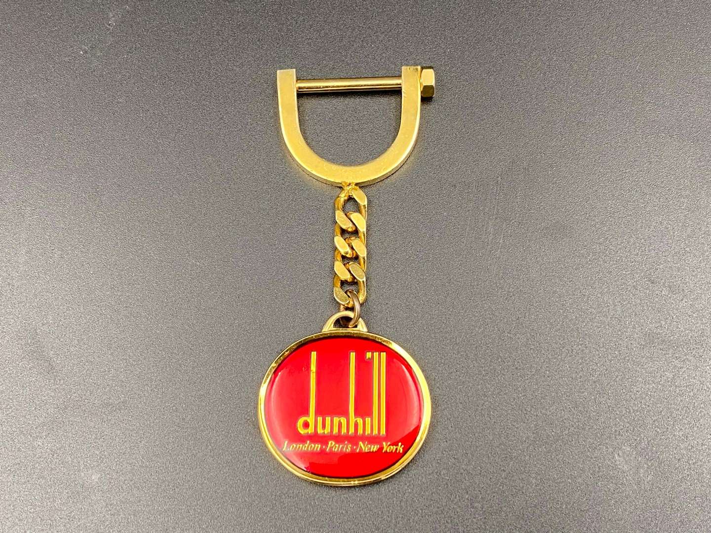 <p>DUNHILL, a gilt plated key ring,</p>