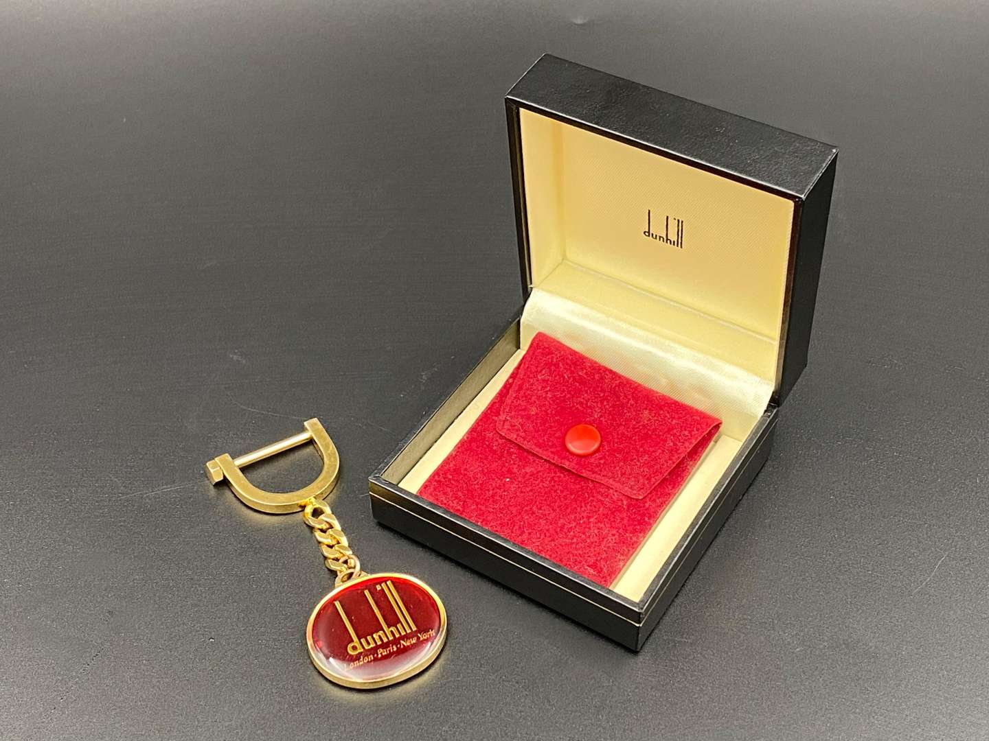 <p>DUNHILL, a gilt plated key ring,</p>