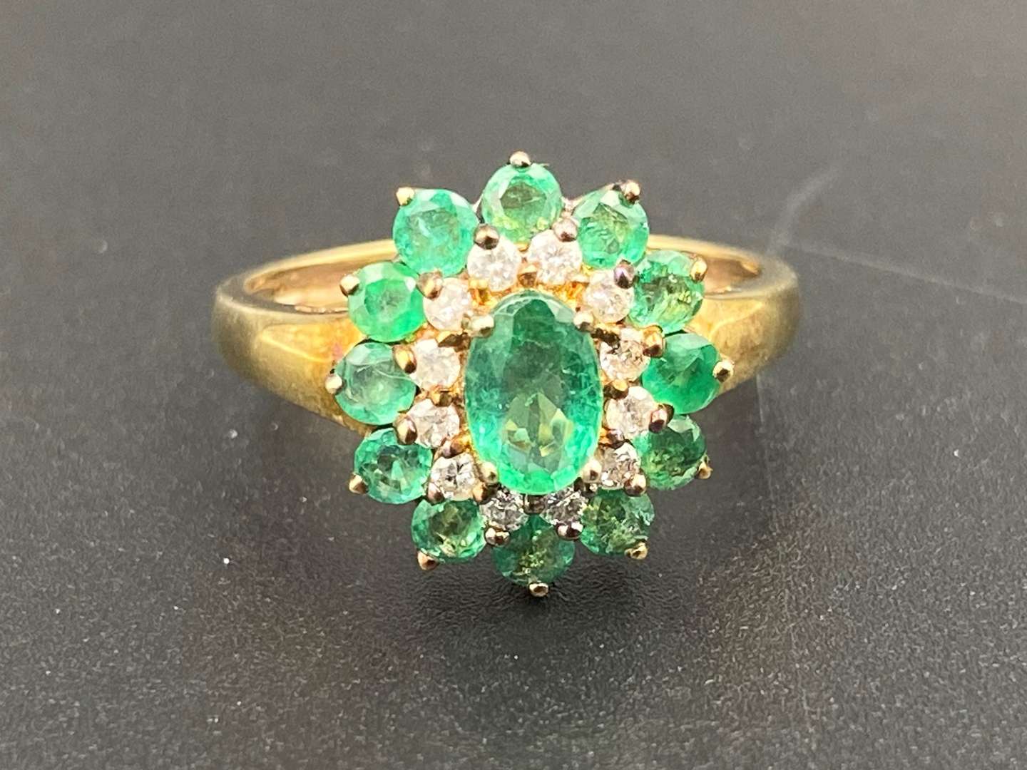 <p>An Emerald & Diamond 9ct gold cluster ring</p>