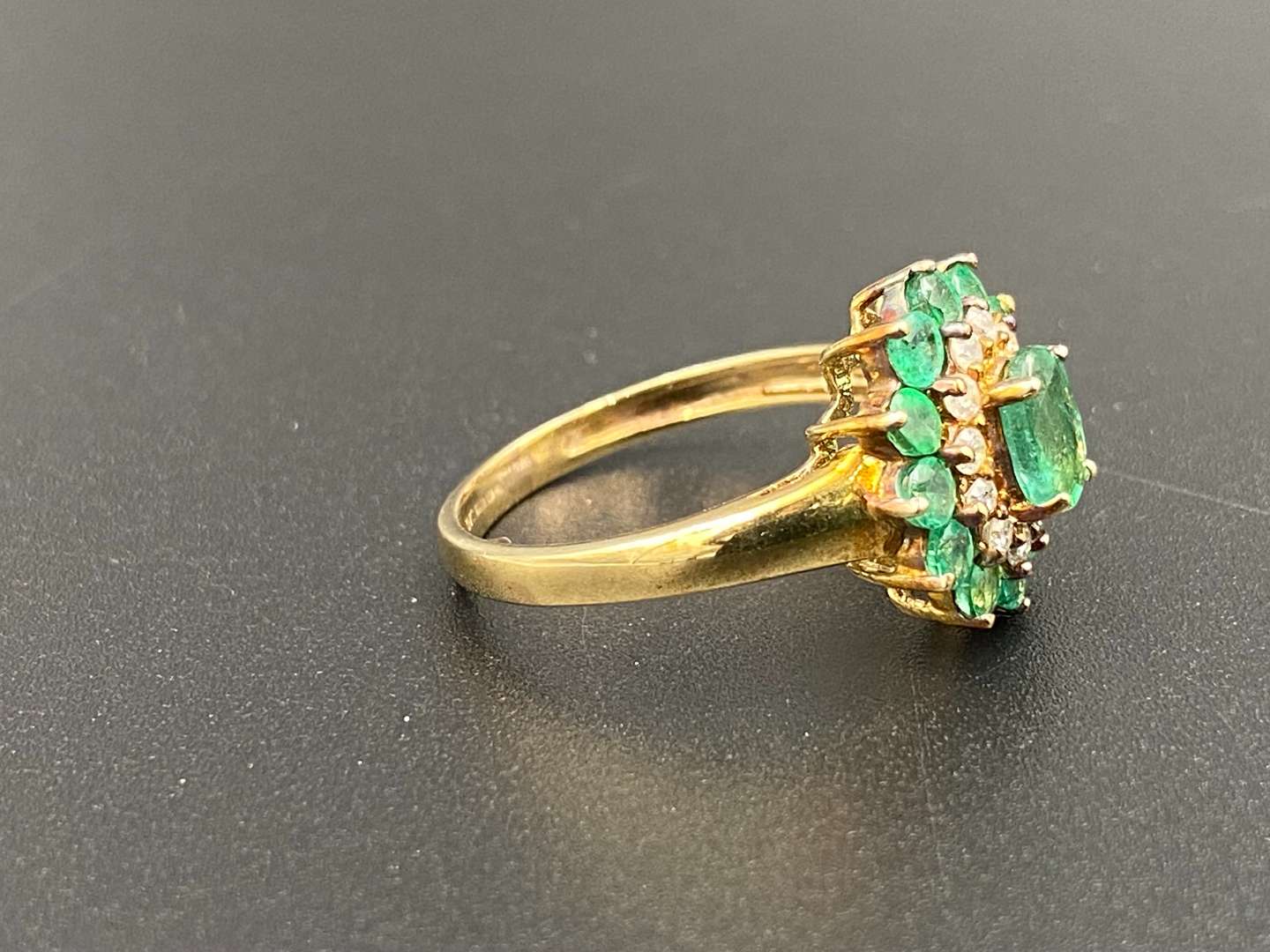 <p>An Emerald & Diamond 9ct gold cluster ring</p>