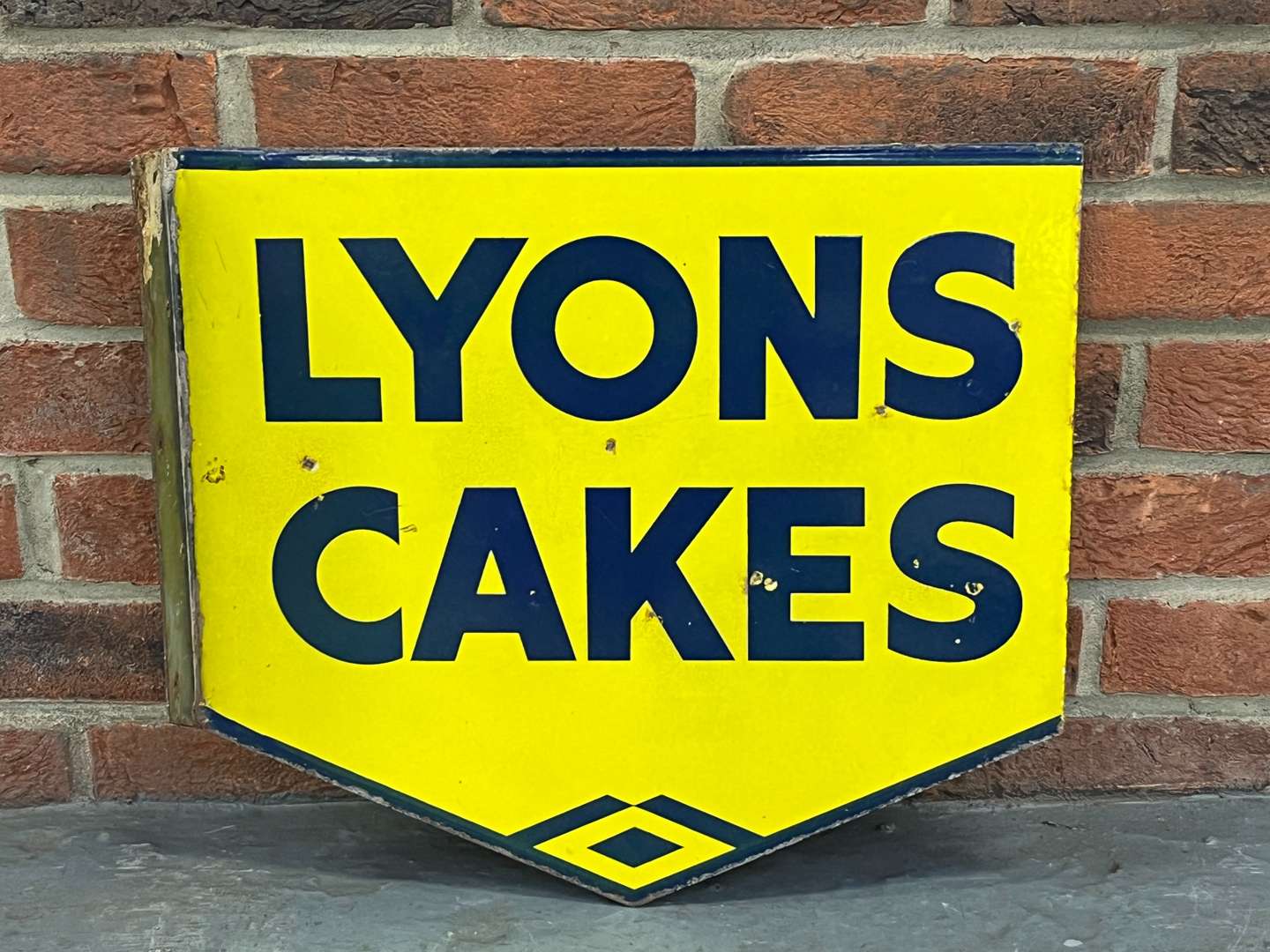 <p>Lyons Cakes Enamel Flange Sign</p>