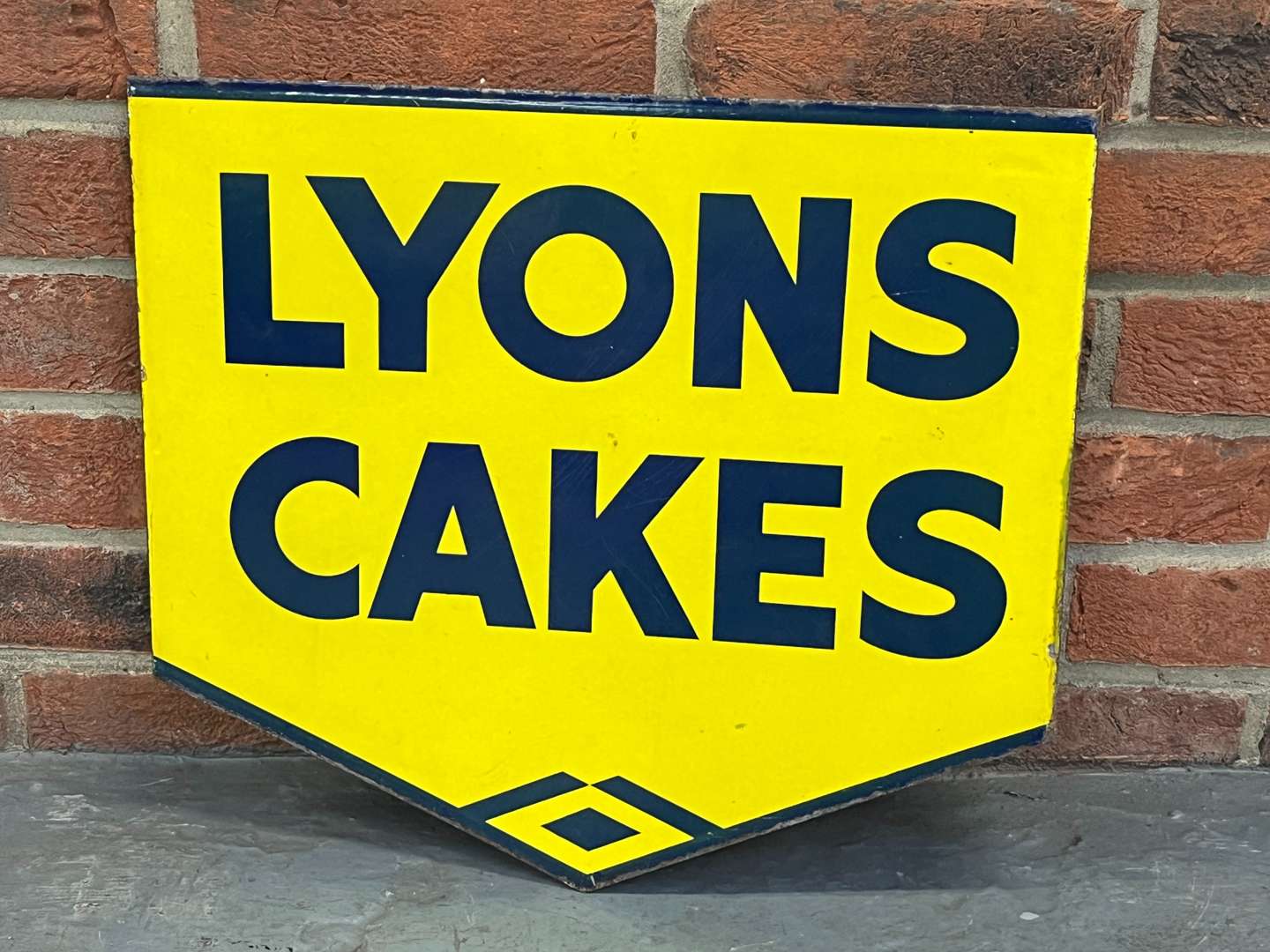 <p>Lyons Cakes Enamel Flange Sign</p>